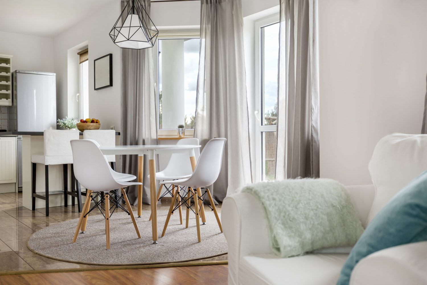 63502531 - new flat with round table, white chairs and open kitchen